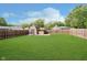 Well-maintained fenced backyard features a lush lawn and a shed; ideal for outdoor activities at 5236 Honey Comb Ln, Indianapolis, IN 46221