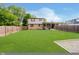 Expansive backyard with a well-kept lawn, fenced perimeter, with an area for relaxing and entertaining at 5236 Honey Comb Ln, Indianapolis, IN 46221