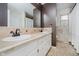 Bathroom featuring dual sinks, white cabinets, and neutral tile creating a functional space at 5236 Honey Comb Ln, Indianapolis, IN 46221
