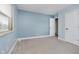 Comfortable bedroom features soft blue walls, carpeted floors, and a bright window at 5236 Honey Comb Ln, Indianapolis, IN 46221