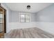 The dining room features attractive plank flooring and is brightened by a sunlit window at 5236 Honey Comb Ln, Indianapolis, IN 46221