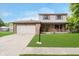 Charming two-story home featuring a brick facade, a two-car garage, and a well-manicured front lawn at 5236 Honey Comb Ln, Indianapolis, IN 46221