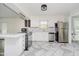 Bright, remodeled kitchen with white cabinets, stainless steel appliances, and stylish tile flooring at 5236 Honey Comb Ln, Indianapolis, IN 46221