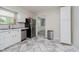 Updated kitchen with white cabinets, stainless steel appliances, and a view into the dining area at 5236 Honey Comb Ln, Indianapolis, IN 46221