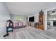 Spacious living room featuring a tv, carpeted areas, and plank flooring at 5236 Honey Comb Ln, Indianapolis, IN 46221