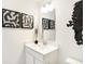 Modern bathroom with sleek white vanity, stylish sink fixtures, decorative art, and great lighting at 5312 Summerton St, McCordsville, IN 46055