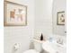 Well-lit powder room featuring modern fixtures, white subway tile, stylish art, and a sleek sink at 5312 Summerton St, McCordsville, IN 46055