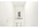 Clean, minimalist bathroom with modern fixtures and a neutral color palette with a unique art piece at 5312 Summerton St, McCordsville, IN 46055