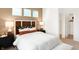 Charming bedroom showcasing a well-decorated bed, natural light from three windows, and neutral wall paint at 5312 Summerton St, McCordsville, IN 46055