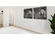 Bright bedroom with a minimalist aesthetic, decorative wall art, and an adjacent hallway, creating a tranquil space at 5312 Summerton St, McCordsville, IN 46055