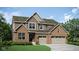 Beautiful two-story home with brick and siding exterior, showcasing a two-car garage and well-maintained lawn at 5312 Summerton St, McCordsville, IN 46055