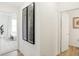 Bright hallway featuring modern artwork, and open access to a bedroom and bathroom at 5312 Summerton St, McCordsville, IN 46055