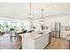 Open-concept kitchen flows into the living area, complete with stainless steel appliances and a large island at 5312 Summerton St, McCordsville, IN 46055