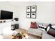 Cozy living room with modern decor, featuring a comfortable gray sofa and stylish wall art at 5312 Summerton St, McCordsville, IN 46055