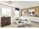 Bright living room featuring modern furnishings, neutral colors, and light wood accent wall with built-in storage at 5312 Summerton St, McCordsville, IN 46055