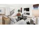 Open-concept living room with fireplace, modern decor, and staircase access, creating a welcoming space at 5312 Summerton St, McCordsville, IN 46055