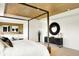 Spacious main bedroom with decorative wood ceiling, large window, accent wall and designer furnishings at 5312 Summerton St, McCordsville, IN 46055