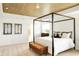 Main bedroom featuring a decorative wood ceiling and an upholstered bench at the end of the bed at 5312 Summerton St, McCordsville, IN 46055