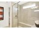 Modern tiled shower featuring a bench seat, glass door, and small window at 5312 Summerton St, McCordsville, IN 46055