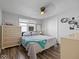Cozy bedroom with wood floor, double window, dresser, and white closet at 547 W Taylor St, Shelbyville, IN 46176