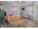 Inviting bedroom featuring wood flooring, soft natural light, and relaxing decor at 547 W Taylor St, Shelbyville, IN 46176