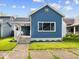 Charming blue two-story home with a quaint front porch and well-maintained lawn during the day at 547 W Taylor St, Shelbyville, IN 46176