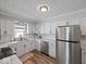 Bright kitchen with white cabinetry, stainless steel appliances, and modern fixtures at 547 W Taylor St, Shelbyville, IN 46176