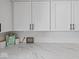 Close-up of kitchen countertops with modern white cabinets and subway tile backsplash at 547 W Taylor St, Shelbyville, IN 46176
