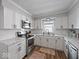 Well-lit kitchen with stainless steel appliances, white cabinets, and sleek countertops at 547 W Taylor St, Shelbyville, IN 46176