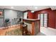 Cozy basement bar with brick accents, overhead lighting, and seating for relaxed entertaining at 6026 Pennyworth Cir, Indianapolis, IN 46203