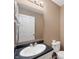 Functional bathroom featuring a toilet, sink with black counter, and large mirror, ideal for quick morning routines at 6026 Pennyworth Cir, Indianapolis, IN 46203