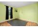 This spare bedroom or workout area features wood-look floors and vibrant green walls for a bright, functional space at 6026 Pennyworth Cir, Indianapolis, IN 46203