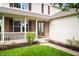 Inviting front porch with white railings and brick accents enhance the curb appeal at 6026 Pennyworth Cir, Indianapolis, IN 46203