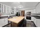 Bright kitchen featuring white cabinets, stainless steel appliances, and a butcher block island at 6026 Pennyworth Cir, Indianapolis, IN 46203