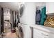 Well-equipped laundry room with stacked washer and dryer, along with storage cabinets and counter space for convenience at 6026 Pennyworth Cir, Indianapolis, IN 46203