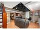 Open-concept living room with plush couches, a unique ceiling, and seamless connection to the bar at 6026 Pennyworth Cir, Indianapolis, IN 46203