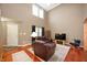 Spacious living room with vaulted ceiling, hardwood floors, and ample natural light at 6026 Pennyworth Cir, Indianapolis, IN 46203