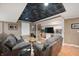 Inviting living room with plush seating, a patterned ceiling, and built-in shelving at 6026 Pennyworth Cir, Indianapolis, IN 46203