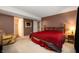 Comfortable main bedroom with carpet floors, a wooden bed frame, and a cozy armchair at 6026 Pennyworth Cir, Indianapolis, IN 46203