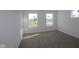 Spacious bedroom with carpeted floors and large windows, offering plenty of natural light at 6223 Medina Spirit Dr, Indianapolis, IN 46237
