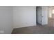 Neutral bedroom featuring a gray carpet, white walls, and an open door at 6223 Medina Spirit Dr, Indianapolis, IN 46237