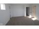 Bright bedroom features neutral carpet, base trim, and multiple doorways at 6223 Medina Spirit Dr, Indianapolis, IN 46237