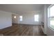 Spacious living room features wood-look flooring, many windows, recessed lighting, and a fireplace at 6223 Medina Spirit Dr, Indianapolis, IN 46237