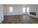 Open concept living room features wood-look flooring, recessed lighting, and a fireplace at 6223 Medina Spirit Dr, Indianapolis, IN 46237