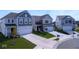 Exterior view of new homes on a manicured street with driveways and landscaping at 6223 Medina Spirit Dr, Indianapolis, IN 46237