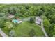 Aerial view featuring a luxurious backyard oasis that includes pool, hot tub, tennis court, and a basketball court at 6230 E 56Th St, Indianapolis, IN 46226