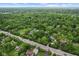 Sprawling suburban landscape with tree-lined streets, residential properties, and a bustling road nearby at 6230 E 56Th St, Indianapolis, IN 46226