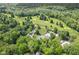 Aerial view of a beautiful golf course and club house surrounded by tennis courts, pools, and lush greenery at 6230 E 56Th St, Indianapolis, IN 46226