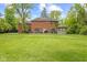 Backyard featuring a gazebo, lush green lawn, and mature trees at 6230 E 56Th St, Indianapolis, IN 46226