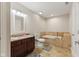 Bathroom featuring a double vanity, tub, and tile flooring at 6230 E 56Th St, Indianapolis, IN 46226